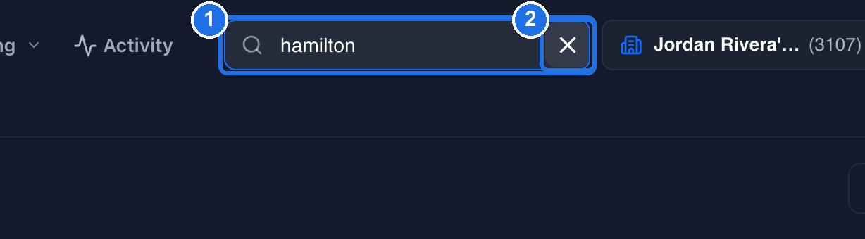 The closed search box still showing hamilton, marked 1, and the clear button at its right end, marked 2
